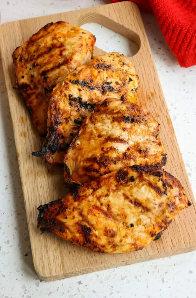 A tasty Buffalo Chicken Recipe made with simple ingredients. Chicken breasts are marinated in homemade buffalo wing sauce and grilled to perfection, making them full of flavor, juicy, and tender. Serve them as the main course or cut them up and use them in a salad with blue cheese dressing, wraps, quesadillas, sliders, and stuffed potatoes.