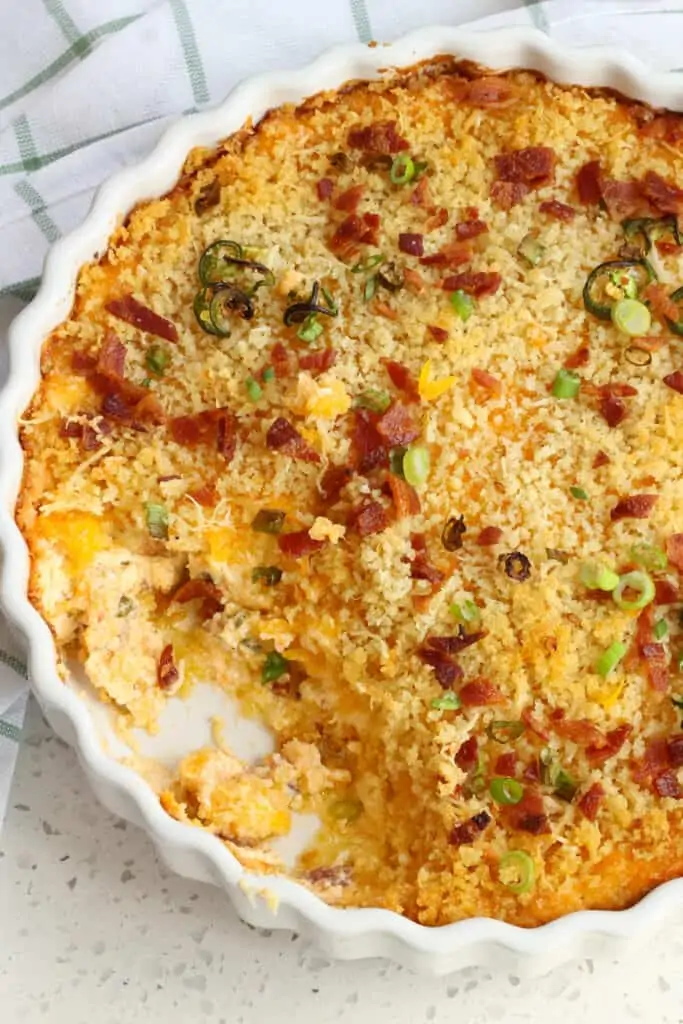 This Jalapeno Popper Dip Recipe is one of our favorite dips with crispy bacon, green onions, and jalapenos, all baked up in a cheddar and cream base with a buttery crumb topping.