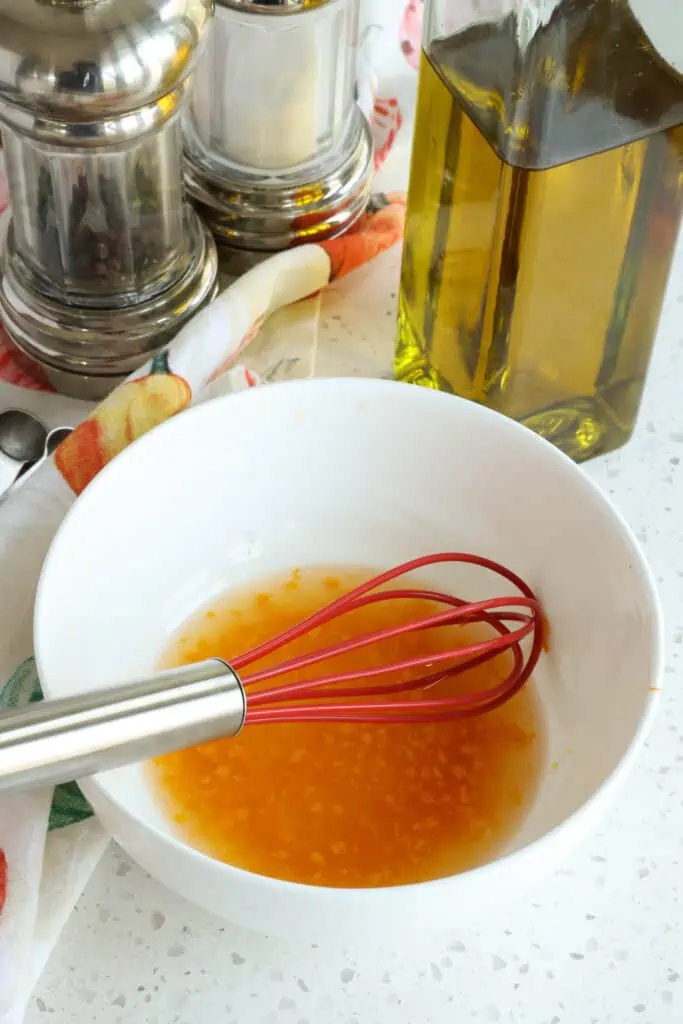 Whisk the ingredients for the salad dressing in a small bowl. 