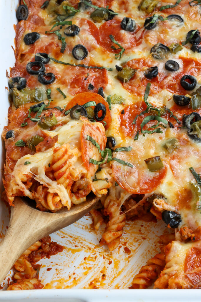 An easy pizza casserole topped with pepperoni, black olives, mozzarella, and basil ribbons.  