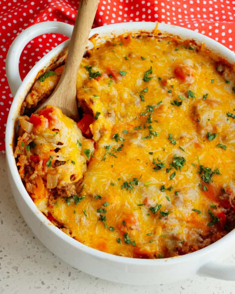 A round white casserole dish full of stuffed pepper casserole.