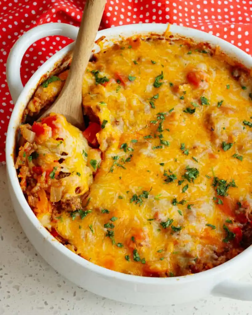 A round white casserole dish full of stuffed pepper casserole.