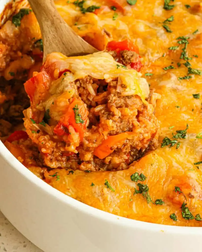 A close up view of a spoonful of stuffed pepper casserole.
