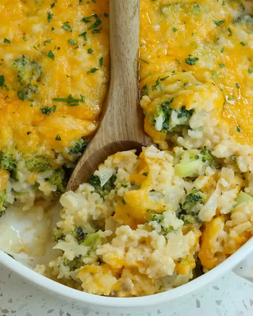 This easy Broccoli Rice Casserole combines fresh broccoli, onions, garlic, and rice with a lusciously creamy cheddar cheese sauce all topped with an extra generous layer of shredded cheddar cheese and Monterey Jack Cheese cheese and baked to perfection. 