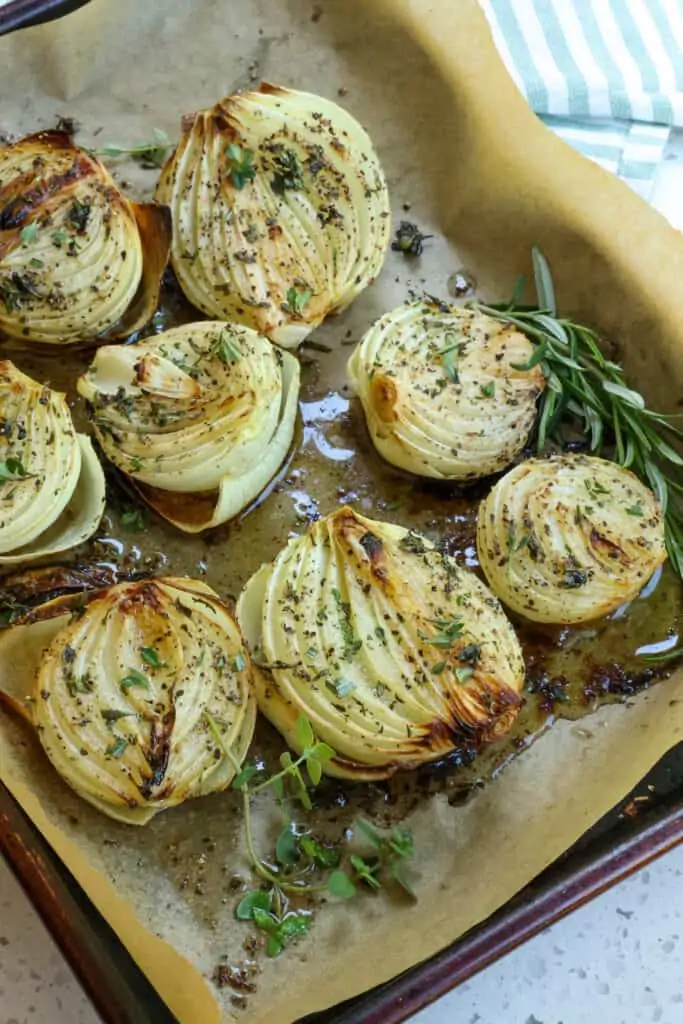 This easy Roasted Onions recipe combines sweet onions with olive oil, butter, kosher salt, fresh ground black pepper, and fresh thyme and rosemary into a flavor packed aromatic side dish.  