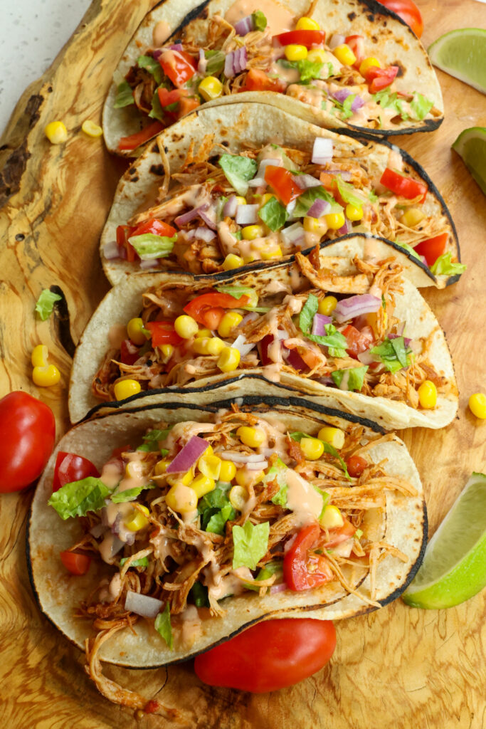 These easy Crock Pot Chicken Tacos are cooked up tender and flavorful with salsa style tomatoes, onions, and taco seasoning. 