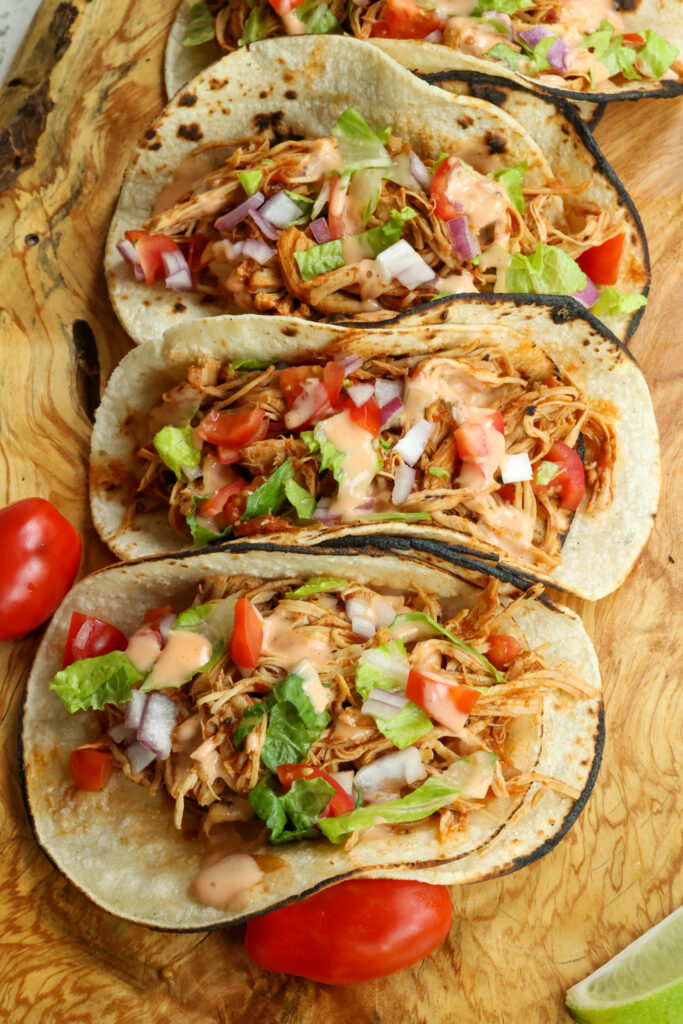 Soon the tender chicken on to corn or flour tortillas.  Customize with all your favorite toppings and drizzle with chipotle ranch.