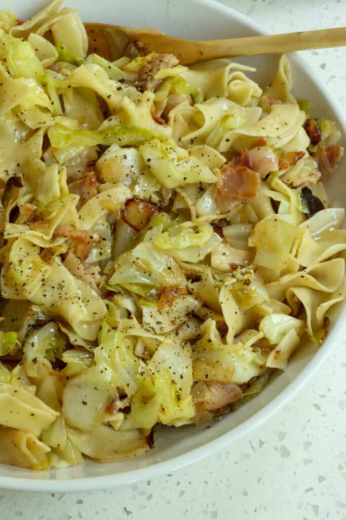 This fantastically simple Traditional Haluski Recipe combines onions, bacon, garlic, and cabbage all cooked in butter and tossed with egg noodles or dumplings.
