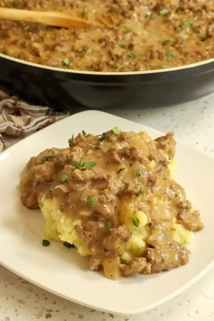 A plate full of hamburger gravy over mashed potatoes. 