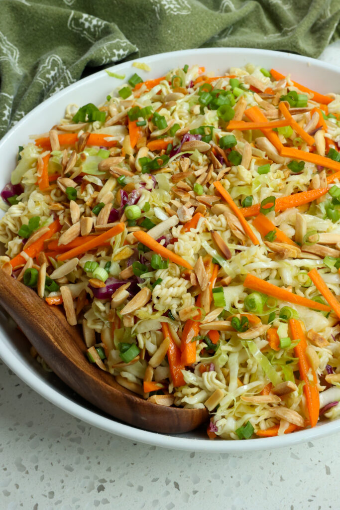 This crunchy Ramen Noodle Salad is loaded with cabbage, carrots, green onions, toasted almonds, and ramen noodles all tossed in an easy garlic honey ginger dressing.  