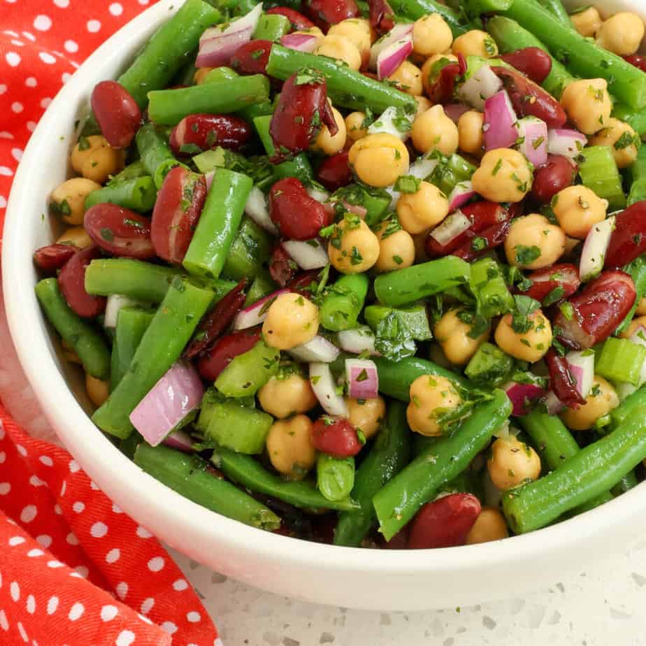 This quick and easy classic three bean salad tossed with a sweet oil and vinegar dressing and fresh herbs is the perfect summer side salad for all your favorite grilled recipes.