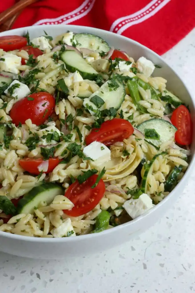 Toss the pasta salad to combine and sprinkle with fresh herbs and gently toss again.   
