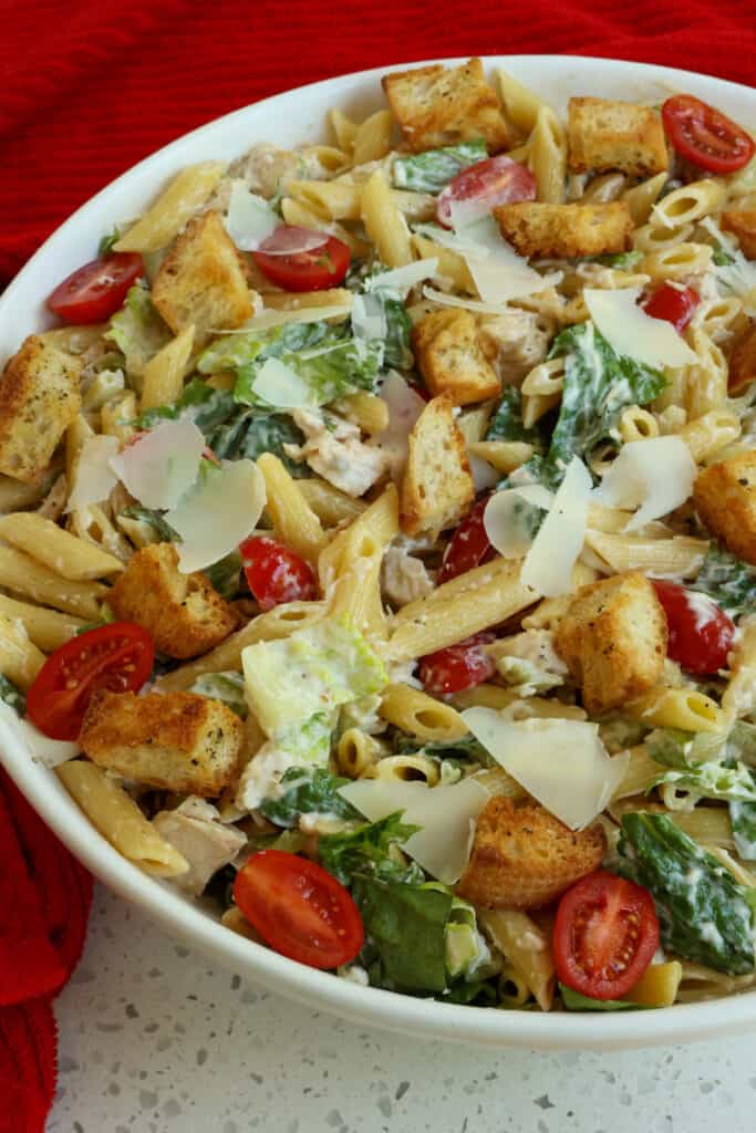 A summer fresh Chicken Caesar Pasta Salad with romaine lettuce, rotisserie chicken, croutons, grape tomatoes, and fresh Parmesan Cheese all in a creamy Caesar Dressing