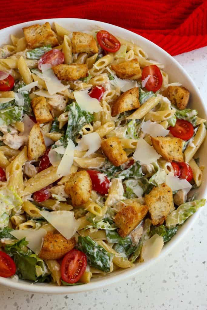 Classic Chicken Caesar Pasta Salad with romaine lettuce, rotisserie chicken, homemade croutons, tomatoes, and fresh grated and shaved Parmesan all tossed in an easy homemade Caesar Salad Dressing. 