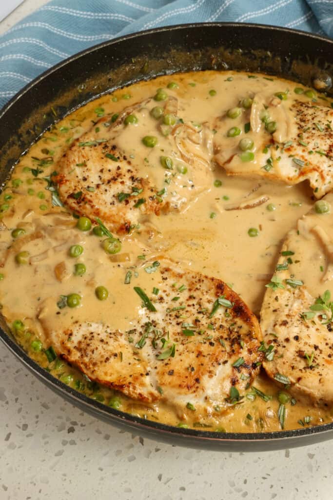 This Chicken Recipe is seasoned browned chicken breasts, garlic, onions, and sweet peas in a creamy Dijon mustard sauce with fresh thyme and rosemary. 