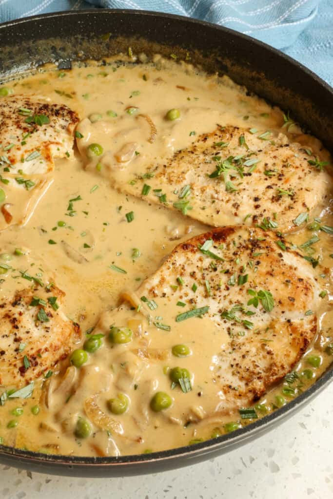 Creamy Dijon Chicken with golden brown chicken cutlets, onions, garlic, and spring peas in a smooth and velvety sauce with a touch of Dijon mustard and fresh herbs. 