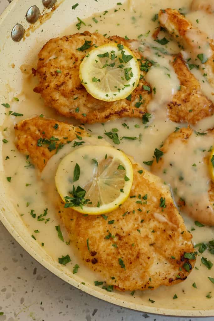 Delicious Italian American Chicken Francese with chicken cutlets dredged in flour, dipped in beaten eggs, and pan fried crisp and served in a lemon white wine sauce. 