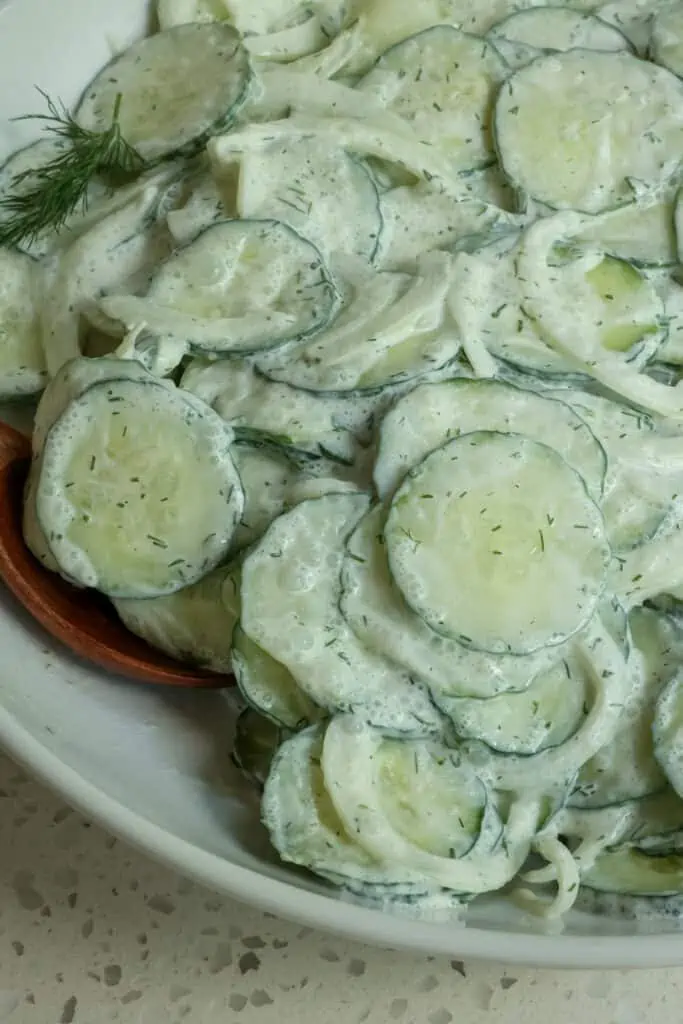 A delicious sour cream based German Cucumber Salad with onion made in less than fifteen minutes.  It is perfect for all your summer picnics, family reunions, and potlucks.