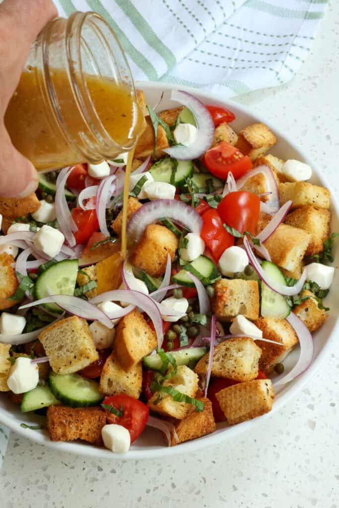 Shake the vinaigrette one more time and drizzle over the bread salad.