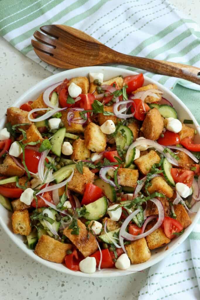 Panzanella is best served shortly after is prepared and tossed. The bread should be coated with the dressing but not soggy. This will happen if you toss the salad too far in advance. 