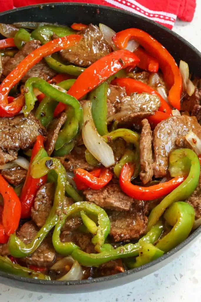 One Skillet Pepper Steak is a super flavor packed stir fry meal full of tender steak, crisp bell peppers, and sweet onions all in a sweet and savory ginger sauce. 
