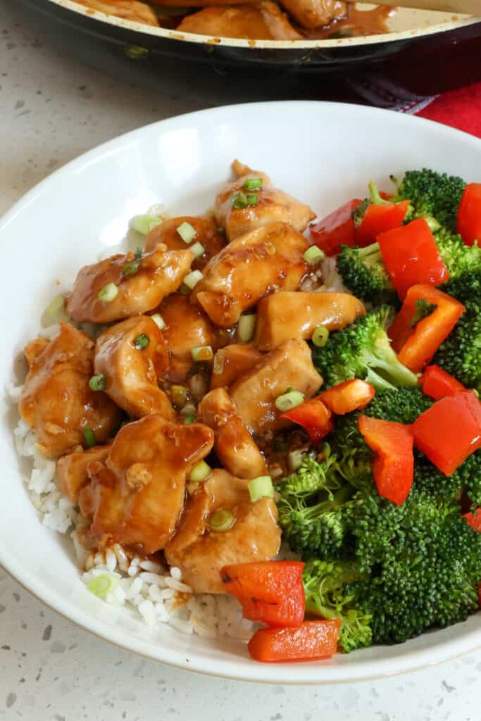 A better than takeout Teriyaki Chicken Recipe made with fresh ginger and garlic served over rice with tender crisp broccoli and red bell peppers