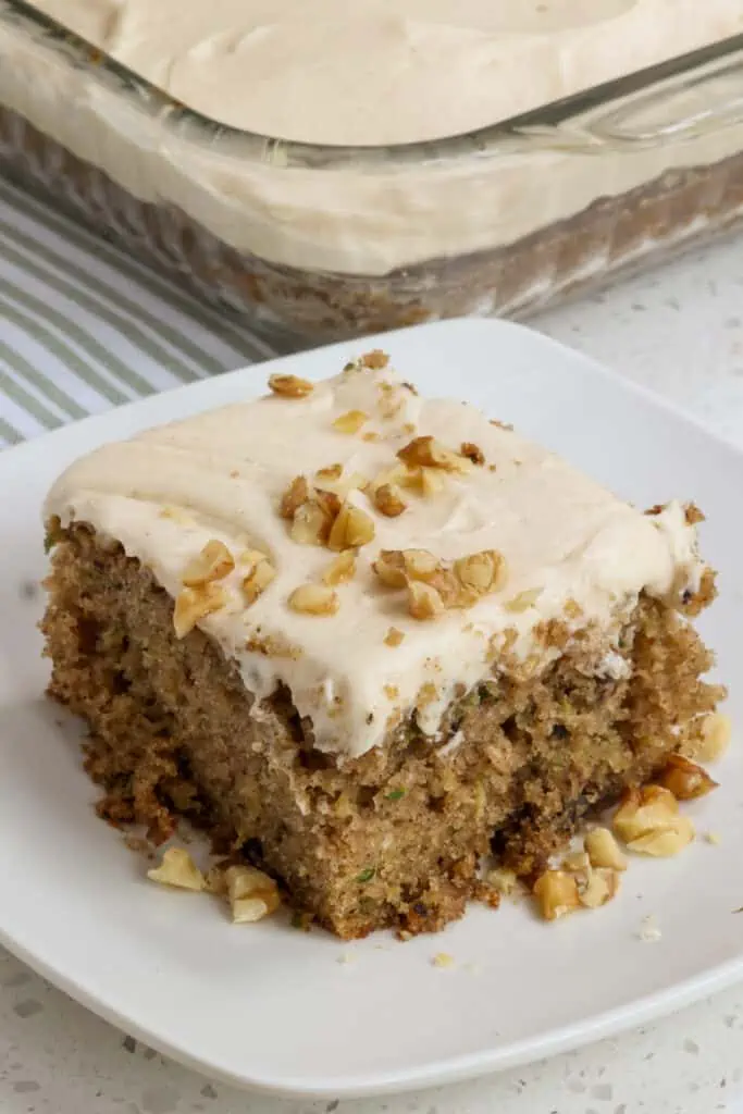 This delicious yet simple Zucchini Cake is made moist with fresh garden zucchini and walnuts.  The warm spices of cinnamon, nutmeg and allspice along with a cinnamon cream cheese frosting take it over the top. 