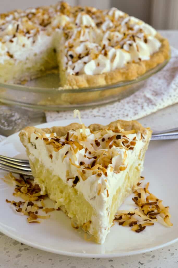 A delicious slice of cream pie with coconut pudding, whipped cream, and toasted coconut. 