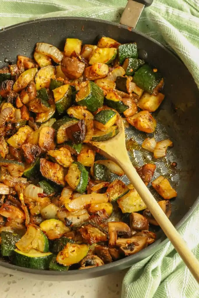 This 15 minute sautéed zucchini recipe combines onions, mushrooms, zucchini, and garlic with a perfect blend of herbs and spices into the best side dish ever.