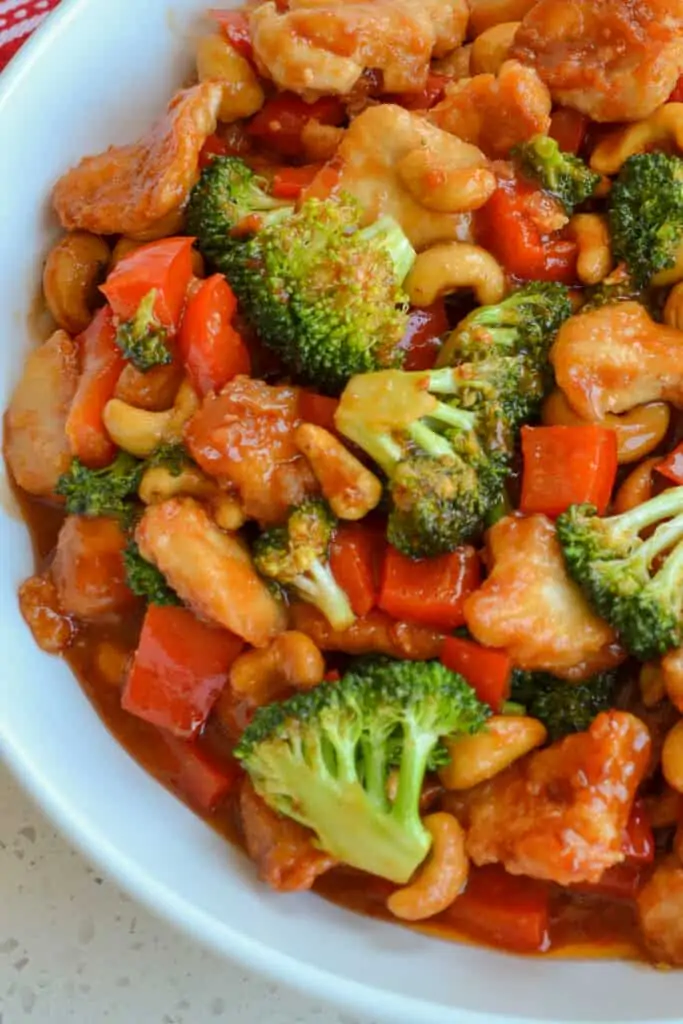 This delectable Cashew Chicken recipe brings crispy pan fried chicken bites, sweet red bell pepper, crisp tender broccoli, and roasted cashews together in a spicy, salty, and sweet mouth watering sauce.