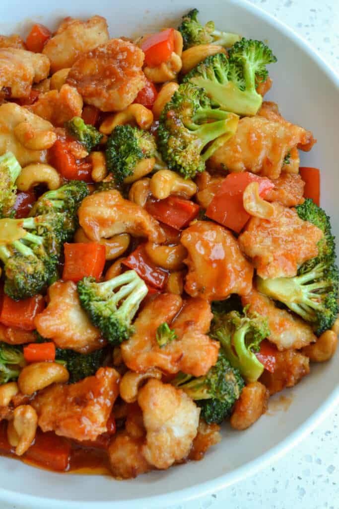 Now in same skillet over medium high heat cook red bell peppers and broccoli until crisp tender.  Then add the chicken, cashews and sauce to the skillet stirring gently to combine.  