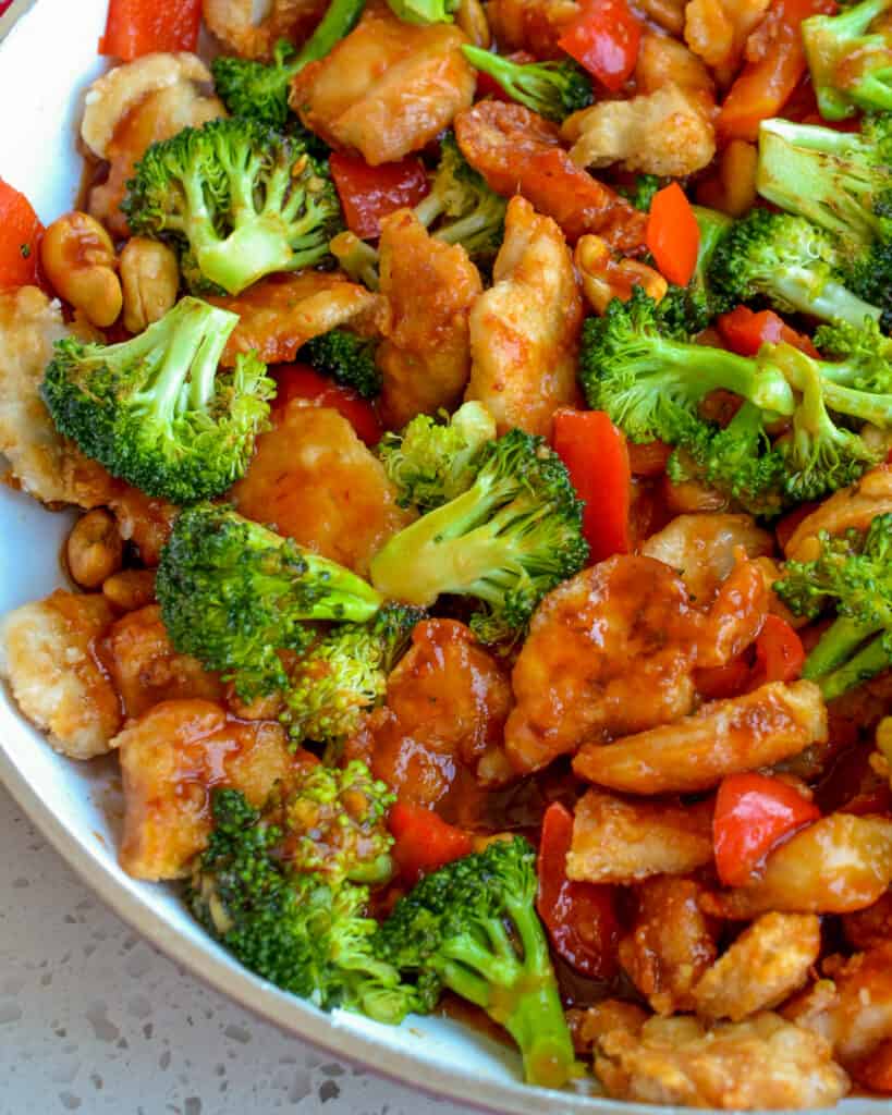 This Cashew Chicken combines crispy pan fried chicken breast pieces with sweet red bell pepper, tender crisp broccoli, and roasted cashews in a slightly spicy sweet and tangy sauce. 