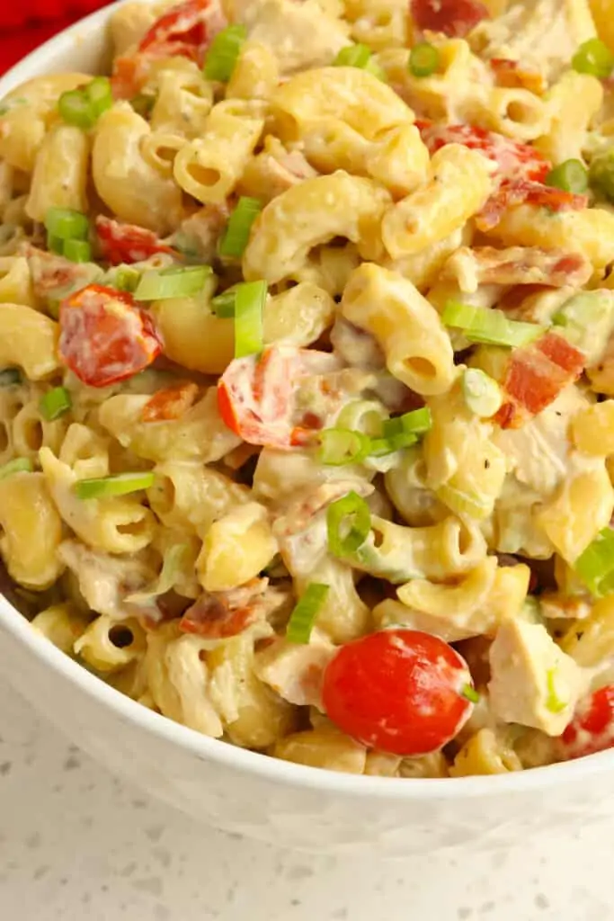 Chicken Pasta Salad Recipe combines elbow macaroni and cooked rotisserie chicken with the flavors of crispy smoked crumbled bacon, grape tomatoes, diced avocado, and green onions, in a creamy mayonnaise dressing with a touch of honey, garlic, and mustard. 