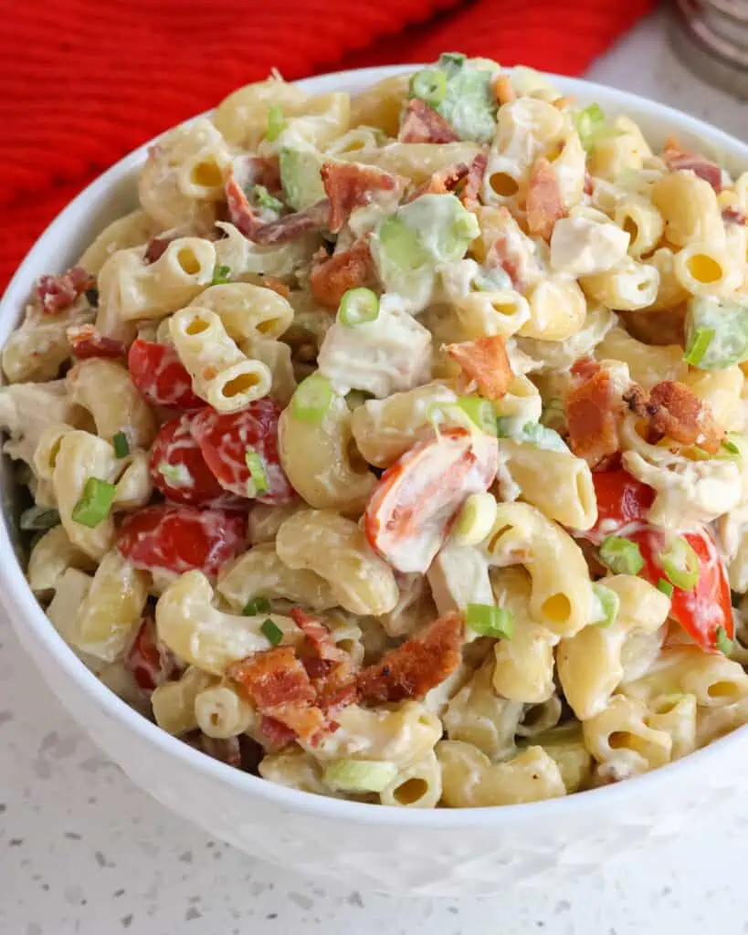 A quick and easy cold Pasta Salad made with already cooked chicken, crispy smoked bacon, tomatoes, and creamy avocadoes, all in a lightly sweetened garlic mustard mayonnaise based dressing  