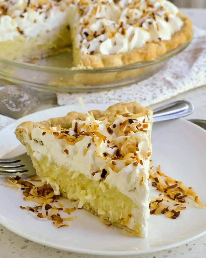 This classic Coconut Cream Pie starts with a buttery flaky pie crust filled with creamy coconut pudding topped with oodles of homemade whipped cream and toasted coconut. 