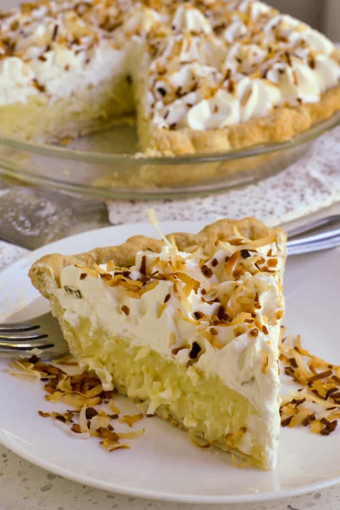 This classic made from scratch Coconut Cream Pie brings it all together with a buttery flaky pie crust, coconut pudding, fresh whipped cream and toasted coconut.