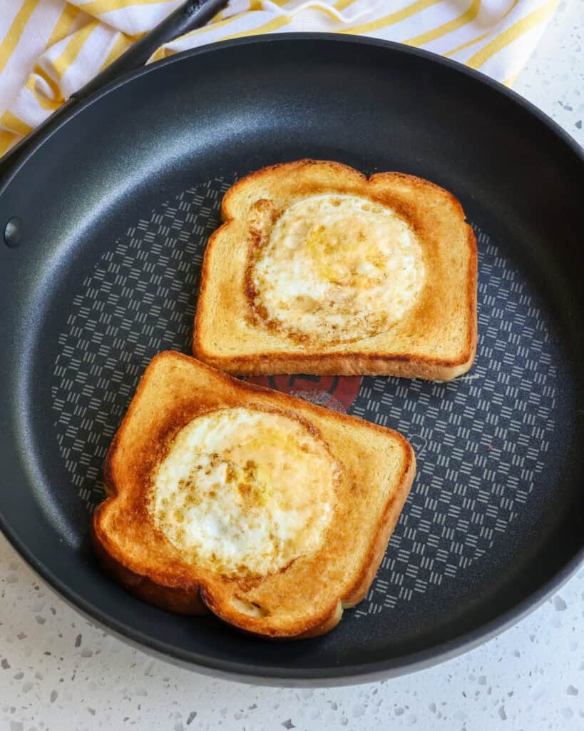 In a skillet over medium heat, add the bread to the pan and crack the egg into the hole. Cook just until set enough to flip.