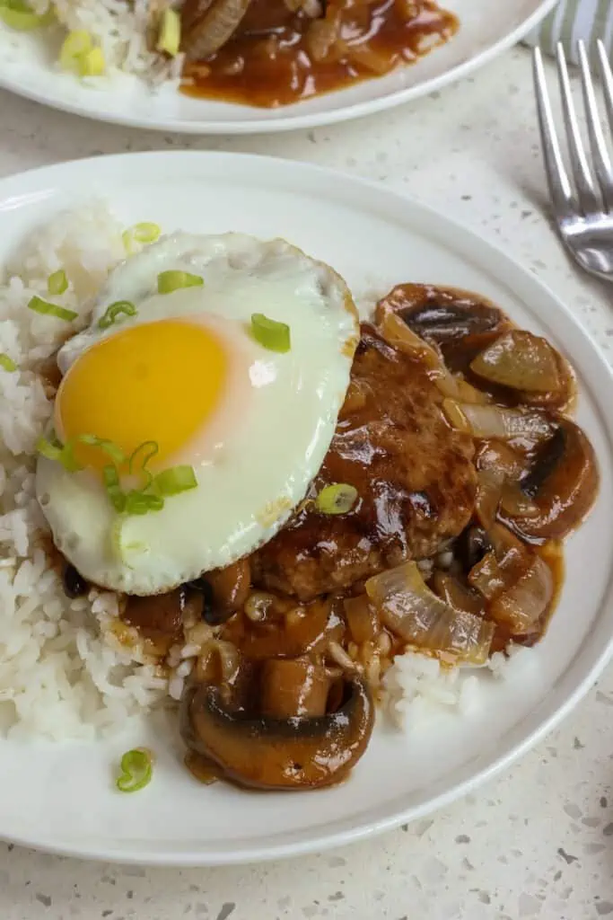Add one cup of rice to each plate or bowl and top with the cooked hamburger patties spooning on extra gravy.  Top each patty with a sunny side up egg and serve. 