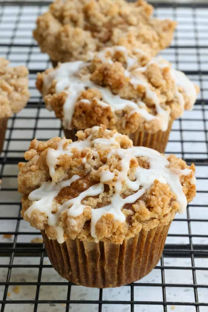 Moist pumpkin muffins with a streusel topping and cinnamon maple drizzle. 