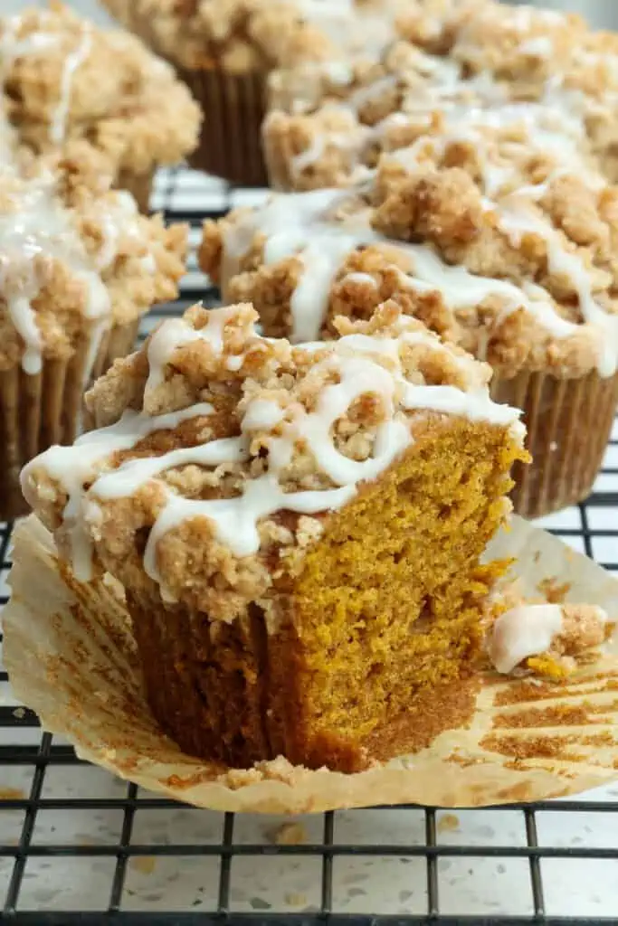 These Pumpkin Muffins bake up super moist and tall, with plenty of pumpkin flavor, covered with an easy buttery crumb topping and drizzled with a quick four-ingredient cinnamon maple glaze.