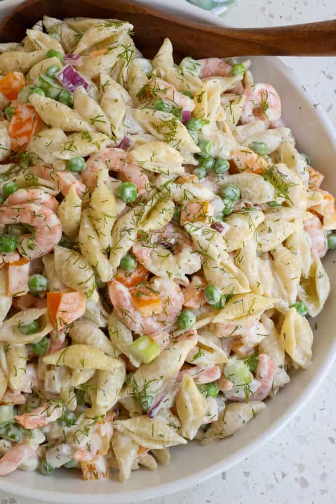 A delicious easy Shrimp Pasta Salad with peas, celery, bell pepper, red onion , and fresh dill in a creamy mayonnaise dressing with a touch of honey, garlic, and mustard. 