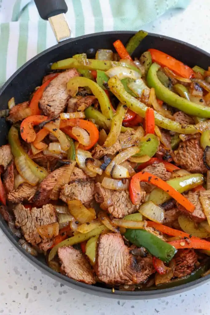 Quick and easy steak fajitas loaded with authentic Mexican flavor, onions, bell peppers, and poblano peppers. 