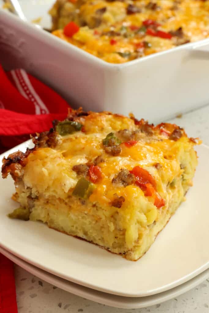 Enjoy this tasty make ahead Tater Tot Breakfast Casserole with plenty of eggs and pork sausage blanketed in layers of cheddar cheese and Monterey Jack Cheese.