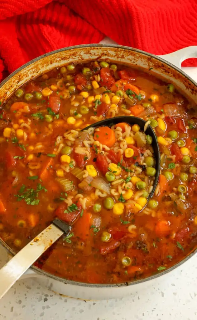 A fun and nostalgic homemade Alphabet Soup with fresh vegetables, tomatoes, peas, and alphabet pasta in Italian seasoned beef broth.