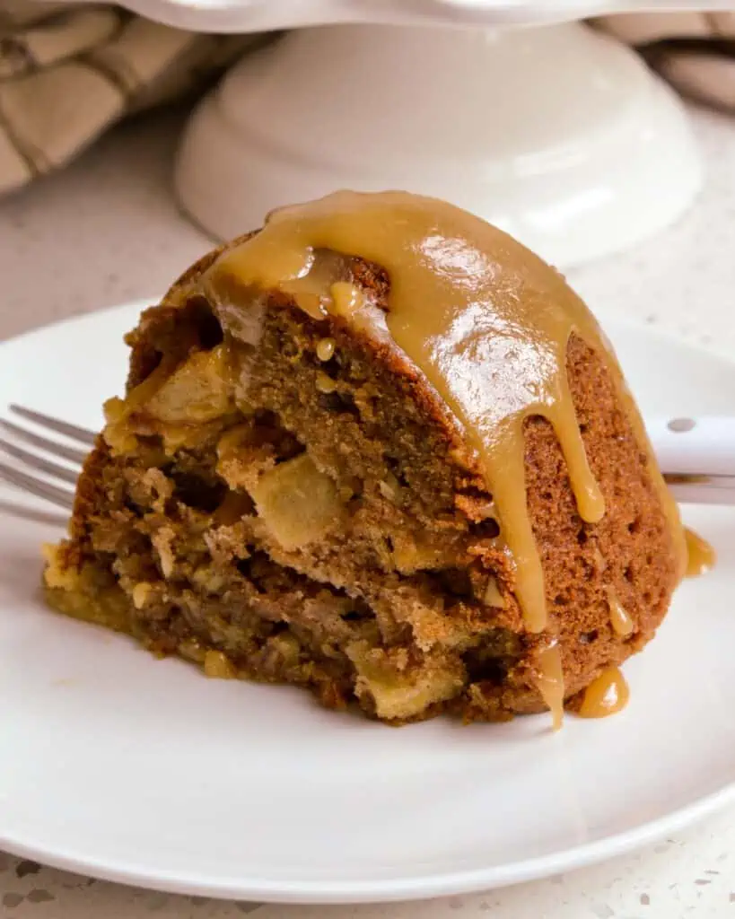 A scrumptiously moist Apple Cake with chunks of fresh apples and pecans in every slice all topped with an easy four ingredient caramel drizzle.