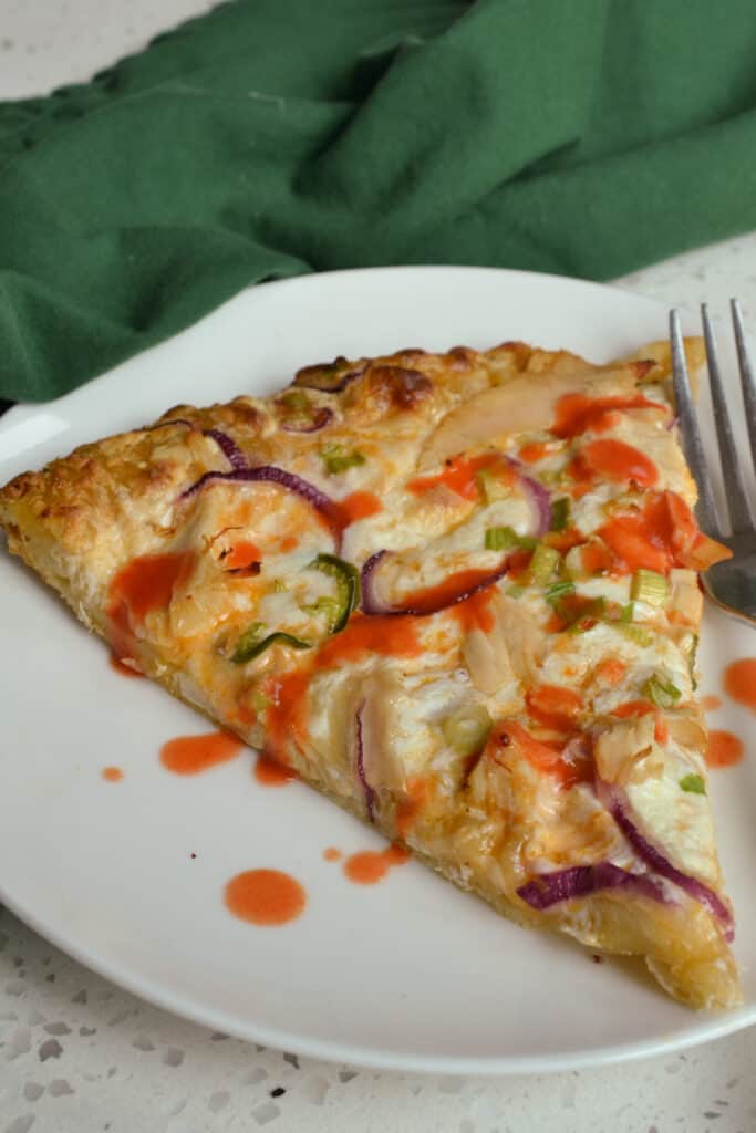 This easy Buffalo Chicken Pizza is made with rotisserie chicken, red onions, thin slices of jalapeno and plenty of fresh mozzarella cheese.