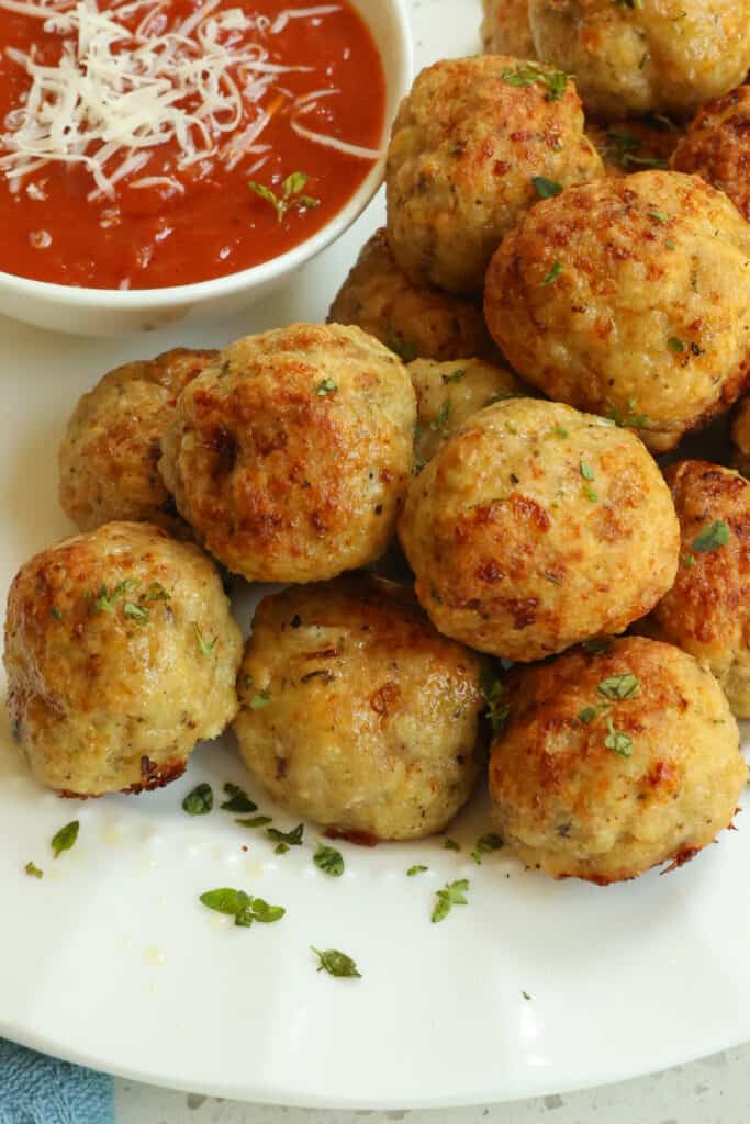 Homemade Chicken Meatballs combine ground chicken with a little finely minced onion and garlic, Italian seasonings, and grated fresh Parmesan Cheese for the ultimate tender and juicy baked meatball experience. 