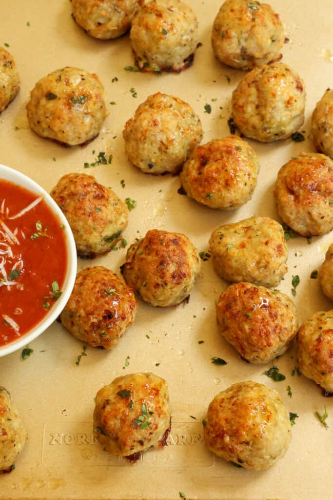Moist and tender Chicken Meatballs mixed with minced onions, garlic, Italian seasoning, and Parmesan Cheese. 