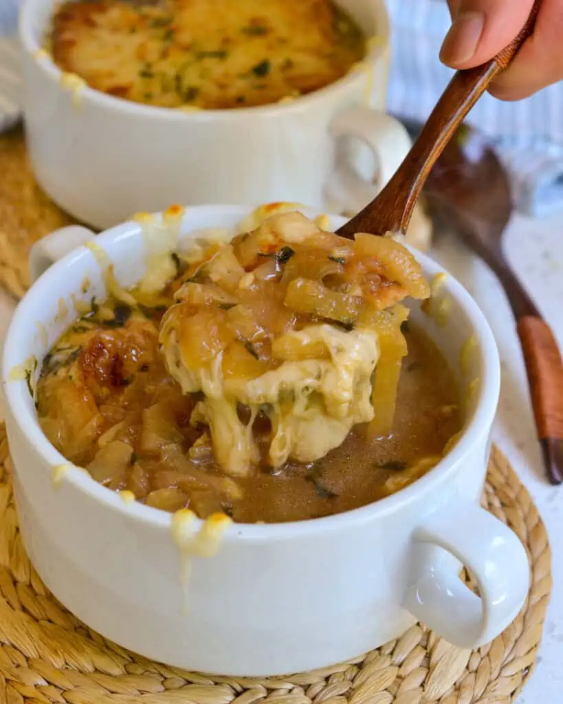 The best French Onion Soup with slow cooked caramelized onions, crisp crostini and plenty of smooth melting Gruyere Cheese.