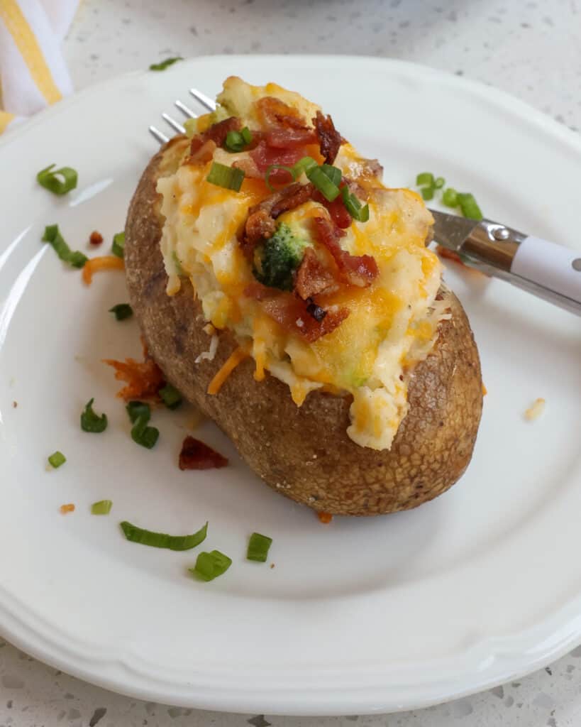 These Loaded Baked Potatoes are stuffed with crisp bacon, steamed broccoli, sweet butter, sour cream, and a generous helping of cheddar cheese and Monterey Jack cheese.